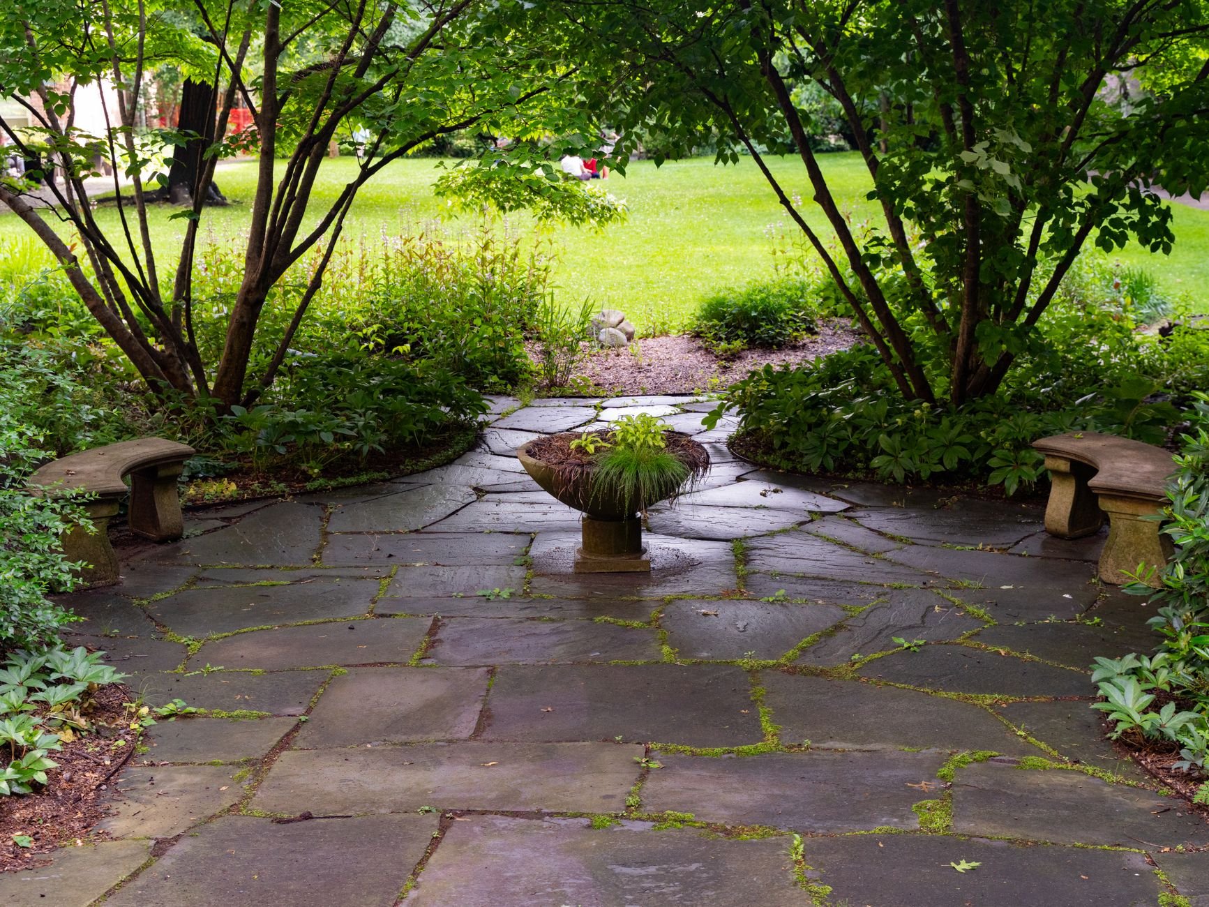 Beautiful stone patio with lush garden surroundings